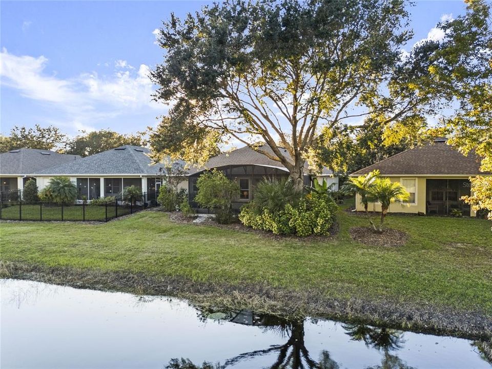 Aerial view of the rear of the home from above the pond