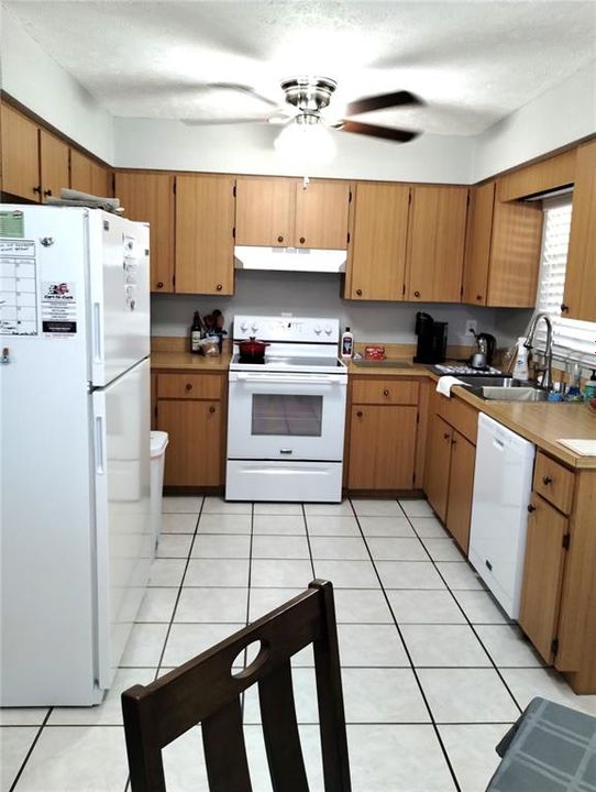 Kitchen includes refrigerator, range, &  dishwasher