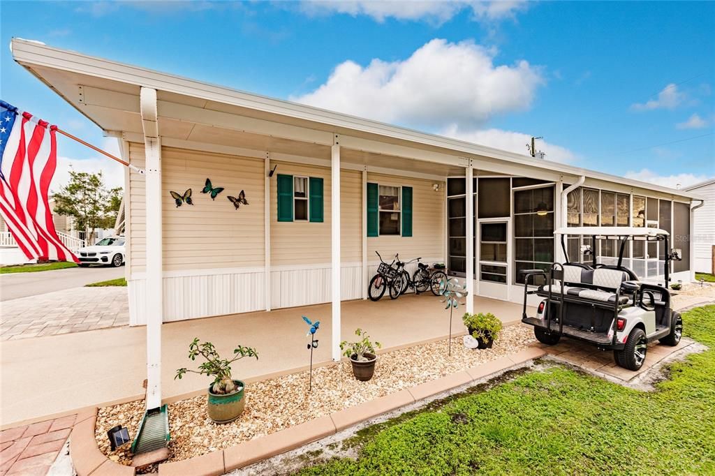 Impeccably Maintained 2005 Manufactured Home with 2 car Carport and Screened Lanai (Golf Cart and Bikes Convey)