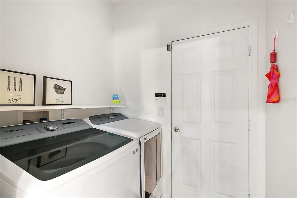 Interior laundry room is located as a pass through between garage and Kitchen area.