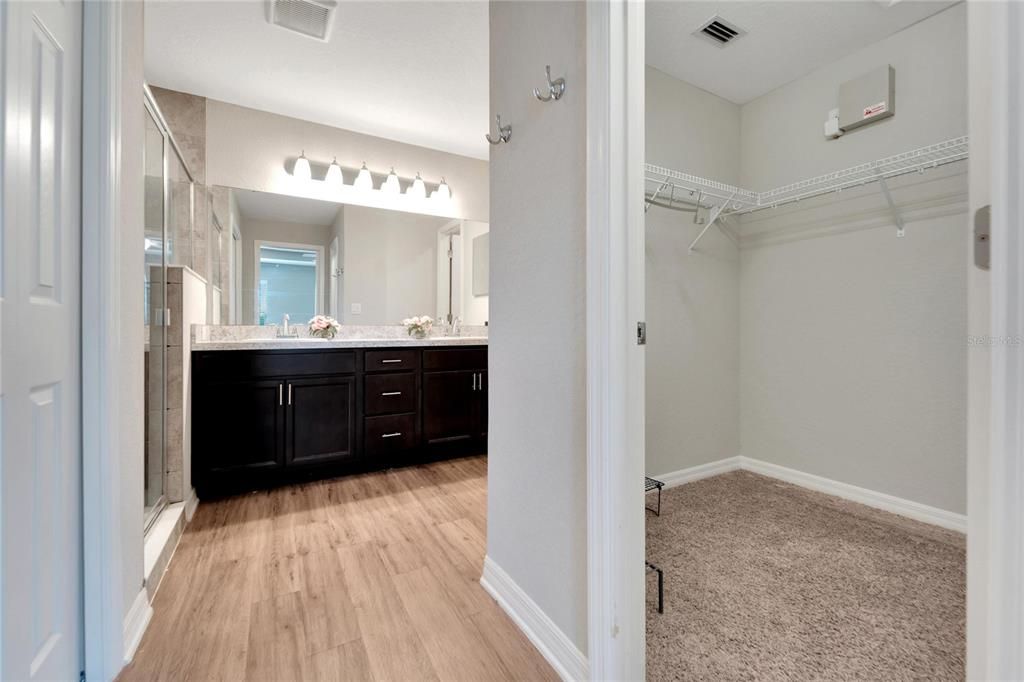 Primary bathroom with dual walk-in closets