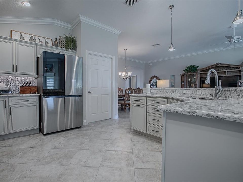 NEW "METAL COOLING" SAMSUNG REFRIGERATOR. DOOR TO THE RIGHT LEADS TO THE LAUNDRY ROOM.