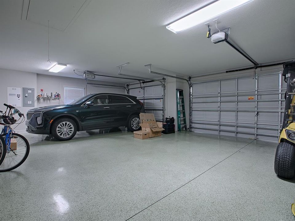 SPACIOUS EXTENDED 3 CAR GARAGE WITH EPOXY PAINTED FLOORING.