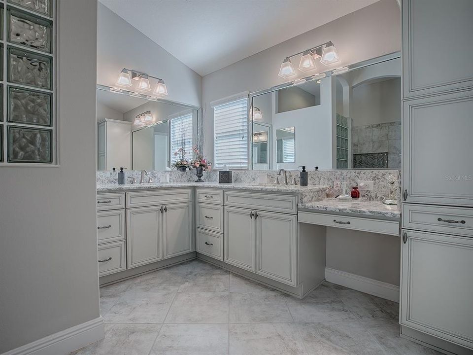 LOVELY BATH WITH VANITY AREA, DUAL SINKS AND LINEN CLOSET.