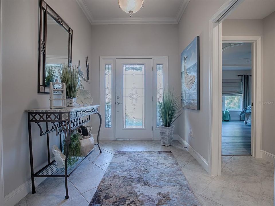 BEAUTIFUL LEADED GLASS FRONT DOOR WITH SIDELITES AND DIAGONAL TILE. GUEST SUITE IS ON THE LEFT UPON ENTERING. AND THERE IS A COAT CLOSET ON THE RIGHT.