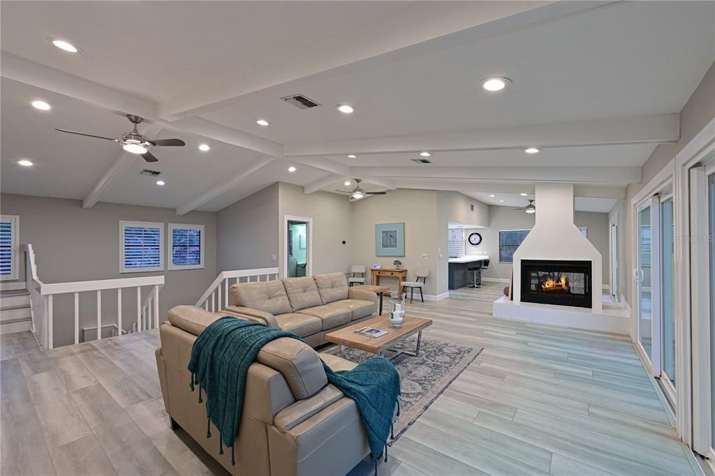 Looking towards dining room separated by double sided fireplace