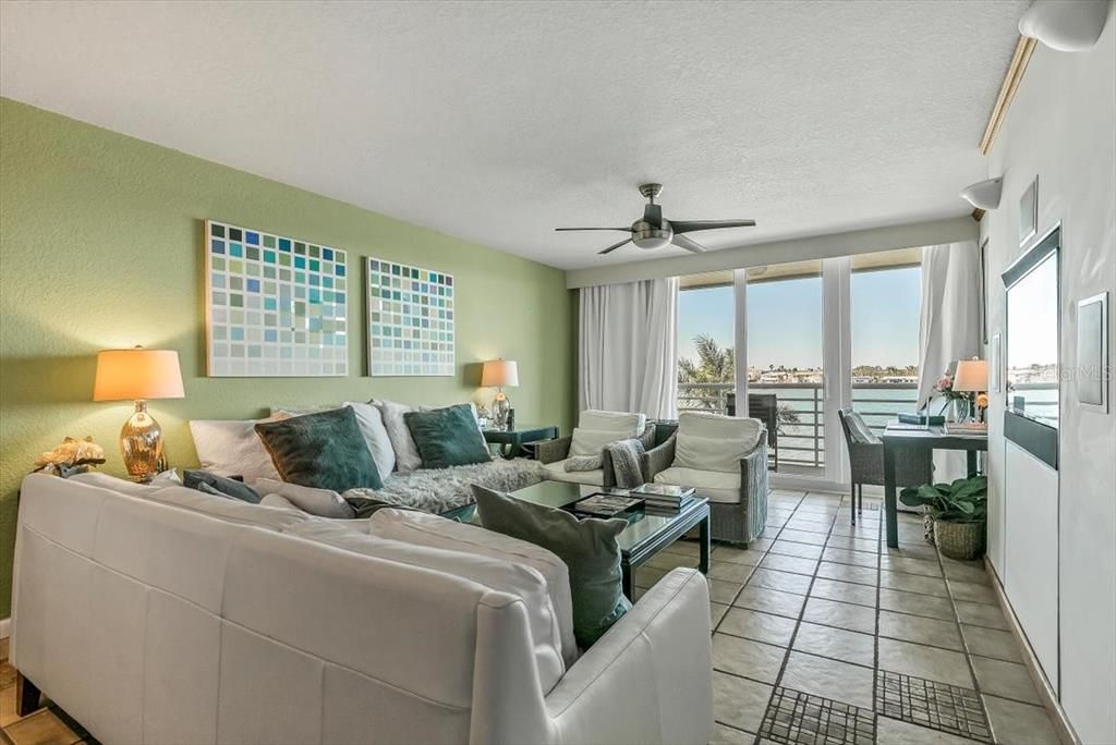 Living room with newer (2019) PGT wind rated sliding glass doors and windows.