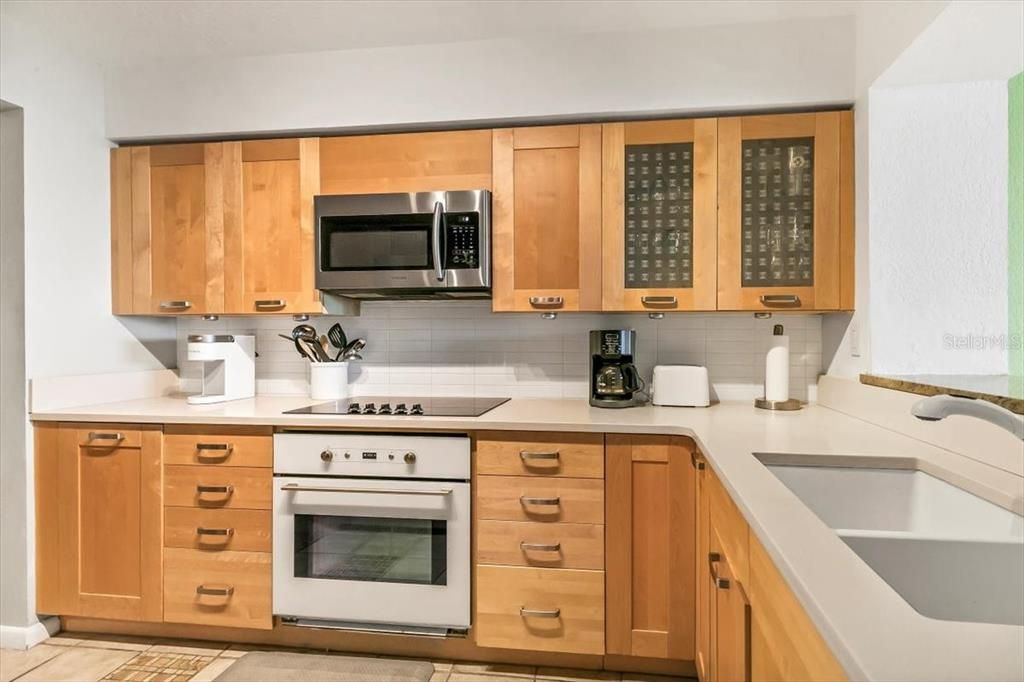 Light and bright custom kitchen with Corian counters.