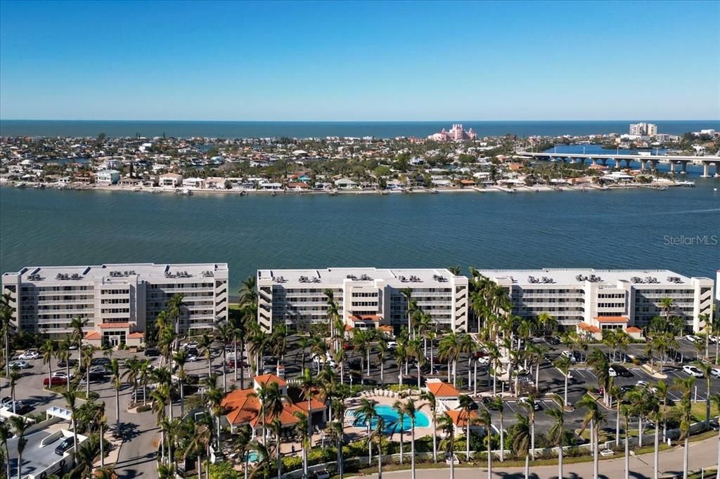 Aerial view to the west with the Don Cesar in the background. Club Bahia clubhouse with fitness room and pool are in the foreground.