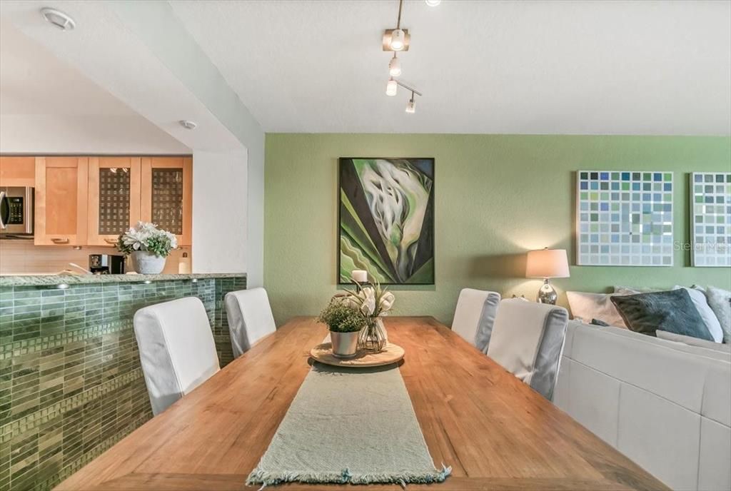 Dining area with kitchen pass through on the left and living room to the right.