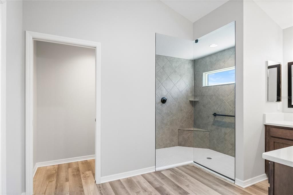 Master Bathroom with water closet, large walk in shower with seating