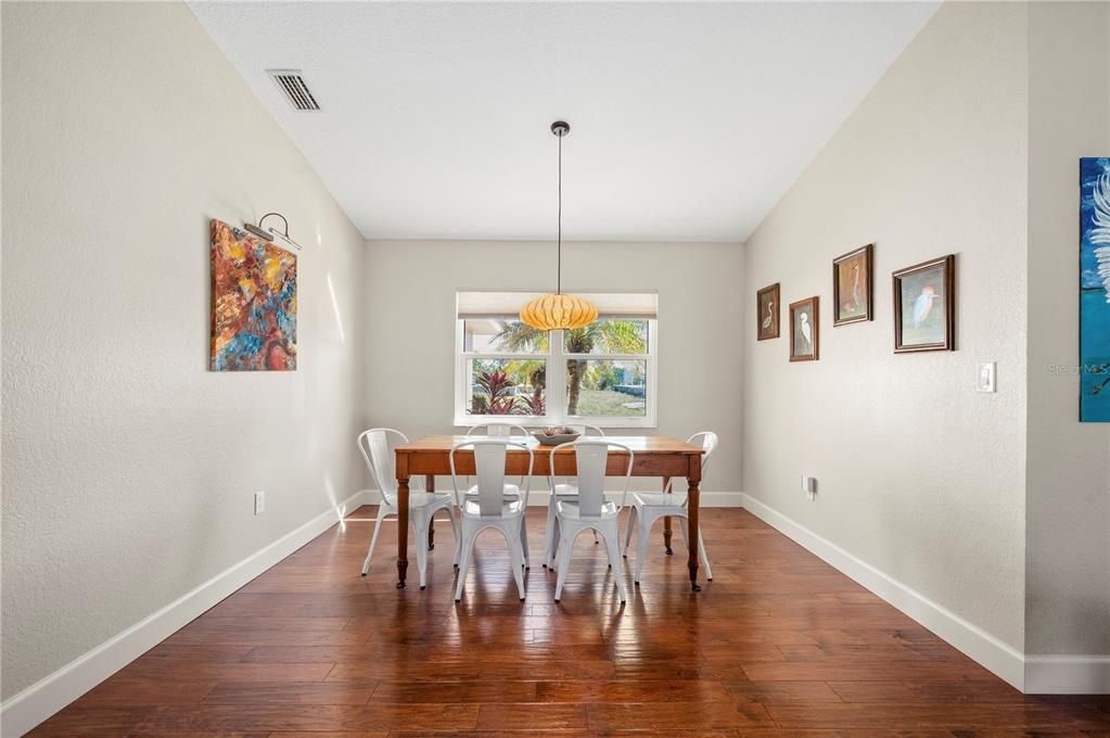 Dining room with custom lighting.  Sorry, table and chairs and framed bird pictures are not available