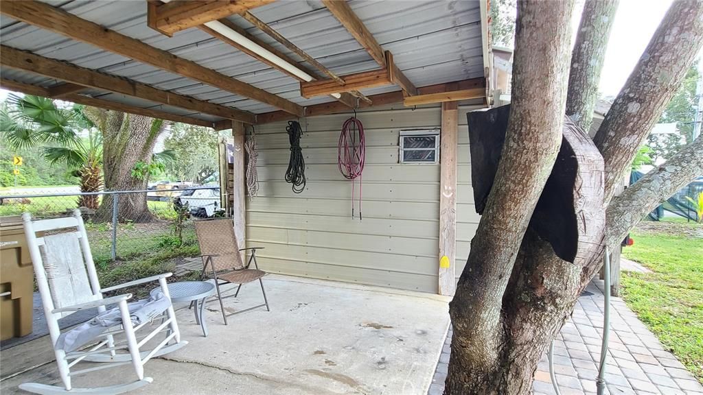 Covered breezeway between porch and detached garage with efficiency.