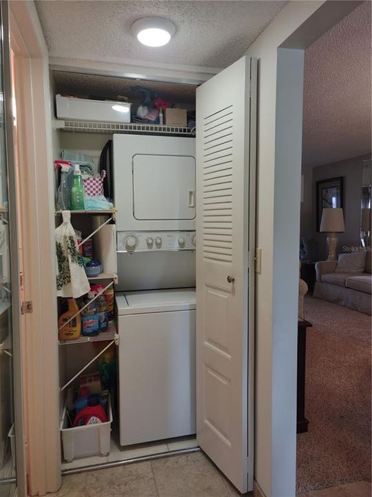 Interior laundry tucked away in hall closet.