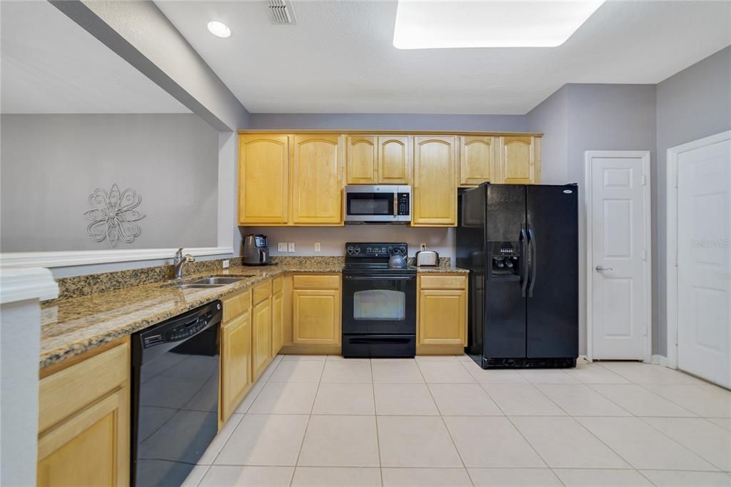 Alternate kitchen view showing pantry and access to the attached garage.