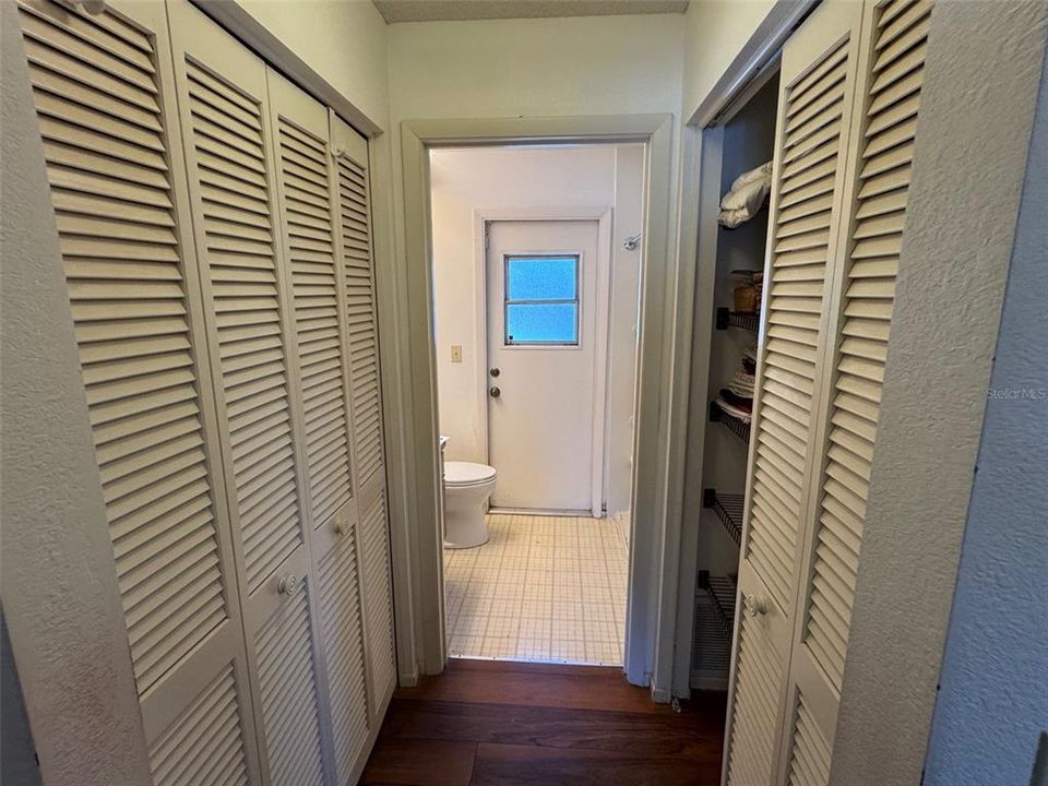 Guest Bath Hall with Closets & Door to the Pool Deck