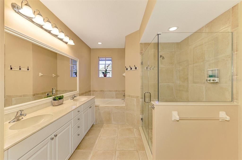 PRIMARY BATHROOM WITH SEAMLESS GLASS SHOWER ENCLOSURE