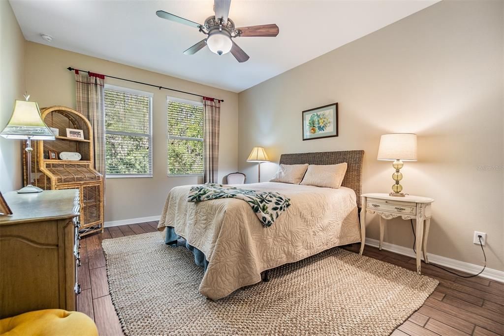 Guest bedroom at the rear of the home with serene wooded views