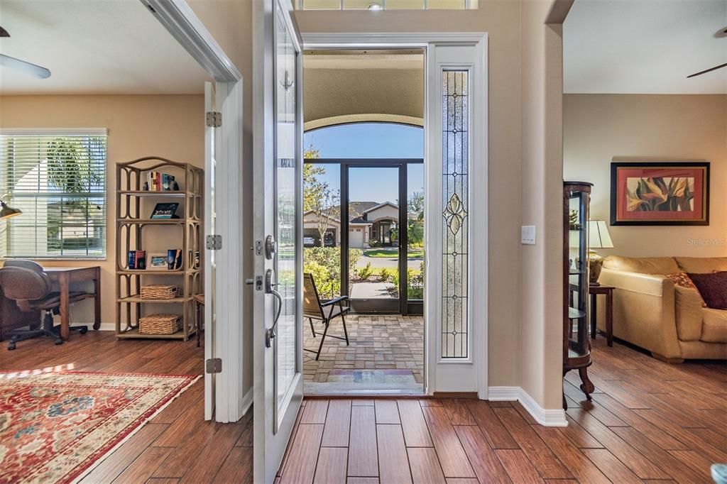 Screened, arched front entry with Pavers welcomes you in!