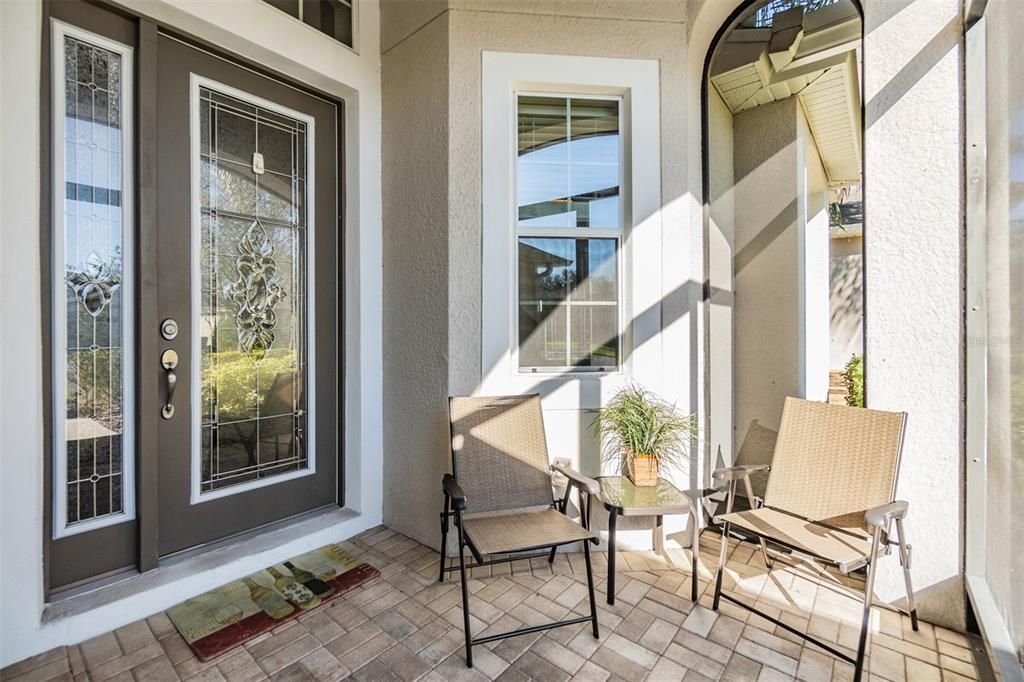 Front porch invites you to sit and stay awhile, screened to enjoy the cross breezes!