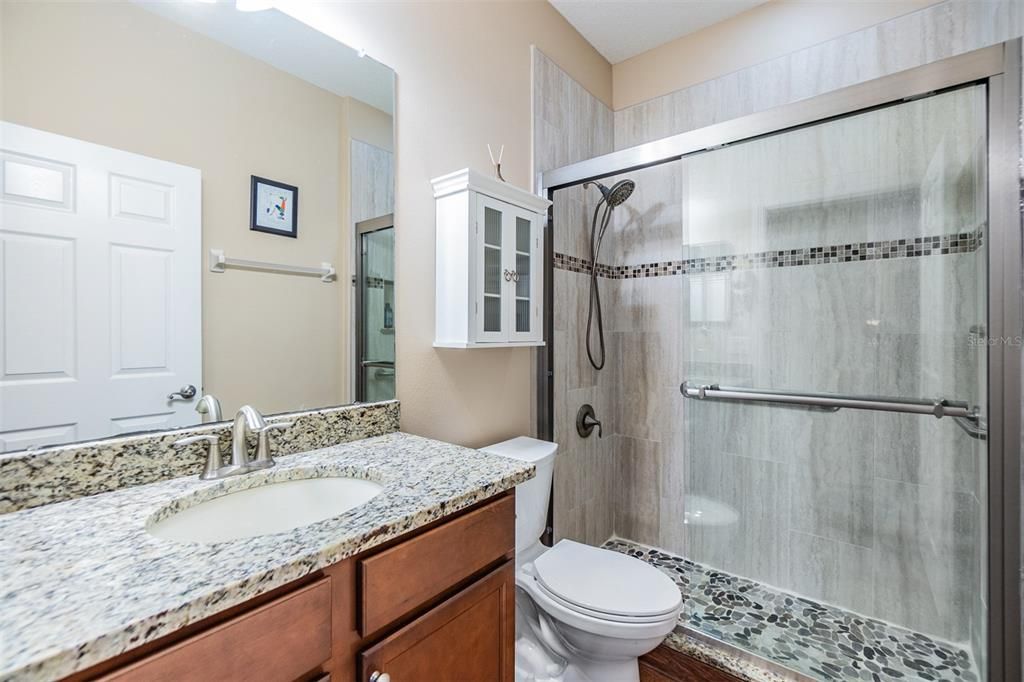 Guest bathroom with UPDATED shower...stunning pebble floor and listello accent band