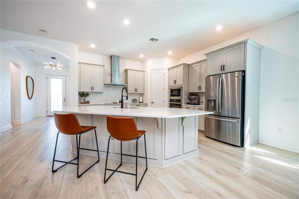 The family chef will fall in love with the gourmet kitchen, perfectly situated at the heart of everything, with a fresh modern color palette, QUARTZ COUNTERS, upgraded STAINLESS STEEL APPLIANCES, ample storage and an OVERSIZED ISLAND with breakfast bar seating.