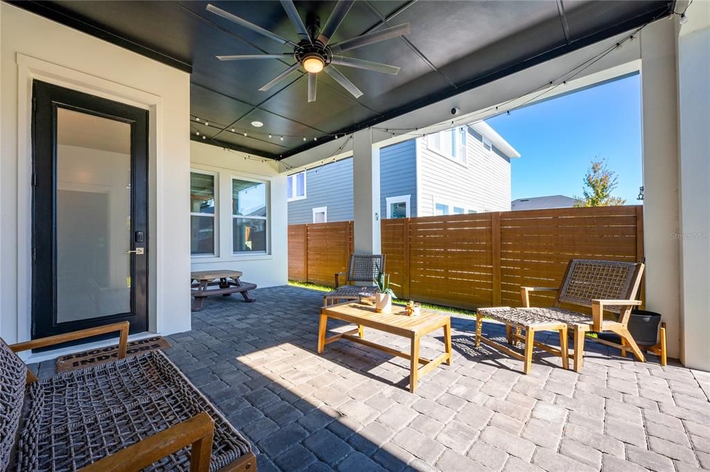 The COVERED PAVER LANAI overlooks a fenced yard for those seeking an outdoor oasis and the 3-CAR REAR FACING GARAGE delivers an EV CHARGING connection.