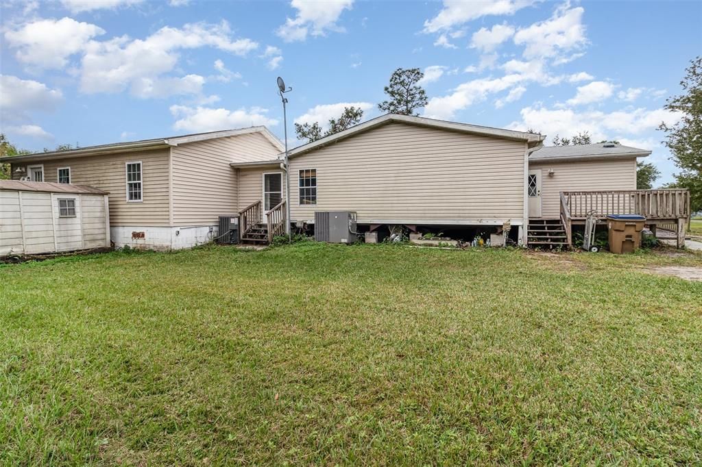 Left Side of Property with In-Law Suite on Left and Main House in Center.  Entry on Left is into Hallway and is Primary Entry for In-Law Suite.  Entry Door on Right is into Main House Kitchen.