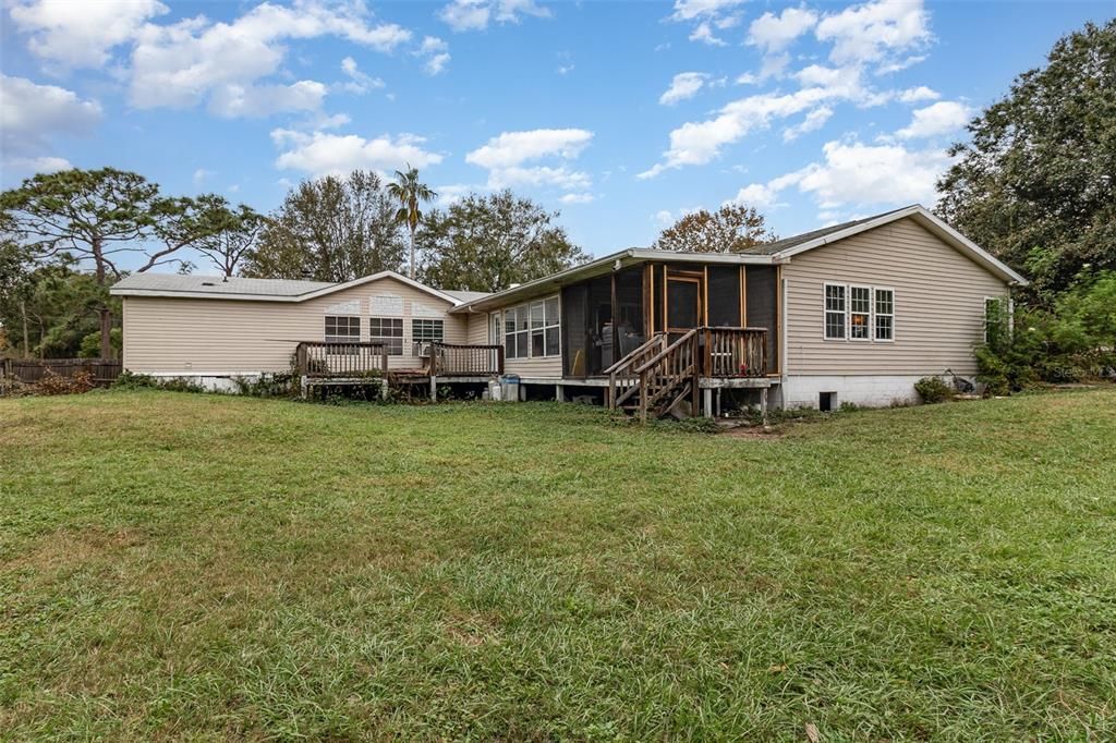 Back of House showing Screened in Porches.  Main House on Left and In-Law Suite on Right.