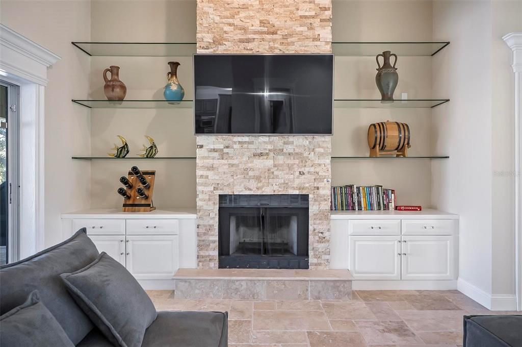 Custom built cabinetry and shelvings surround fireplace