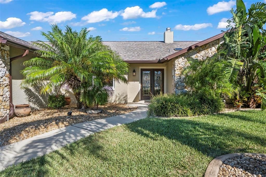 Mature landscape and concrete curbing as garden feature around entire home