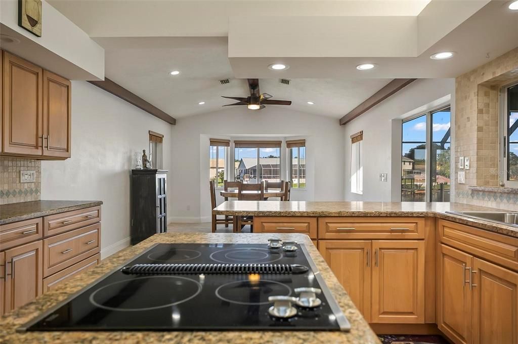 Well placed center kitchen island with built in stove top!