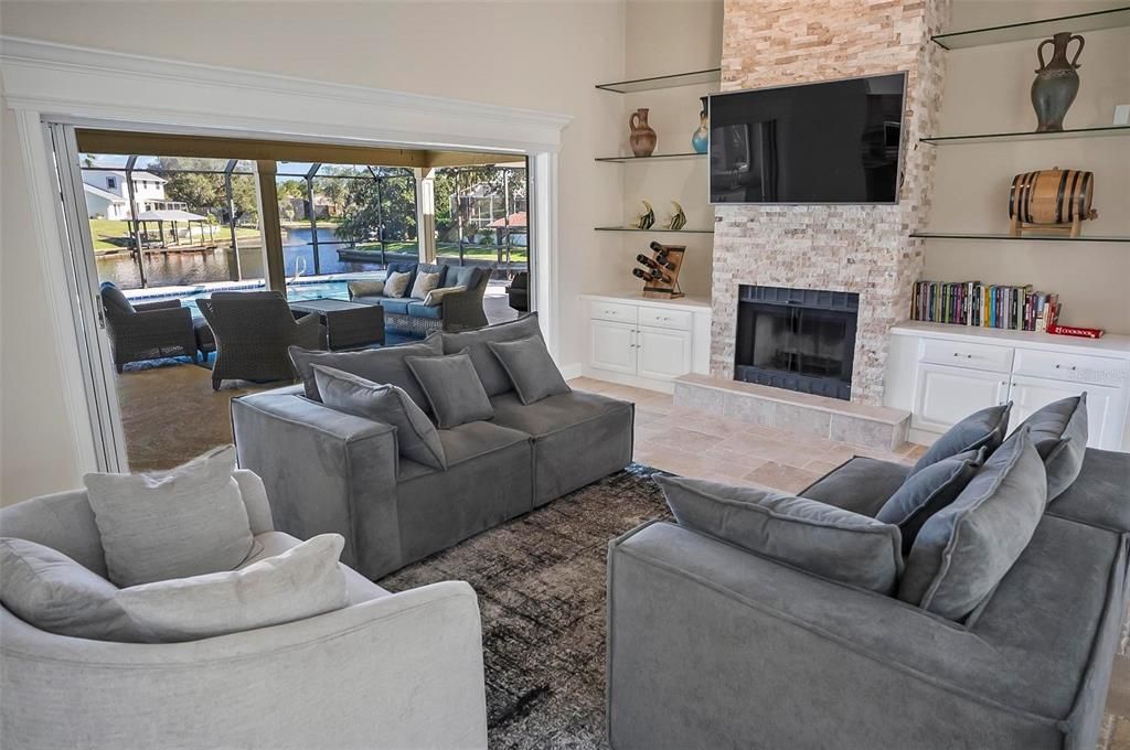 Custom travertine flooring and travertine stacked fireplace in open concept living room!