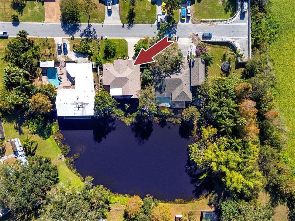 Aerial view of the house, the lake, Kapok Terrace Park, softball/soccer fields/Bayside Bridge and Tampa Bay