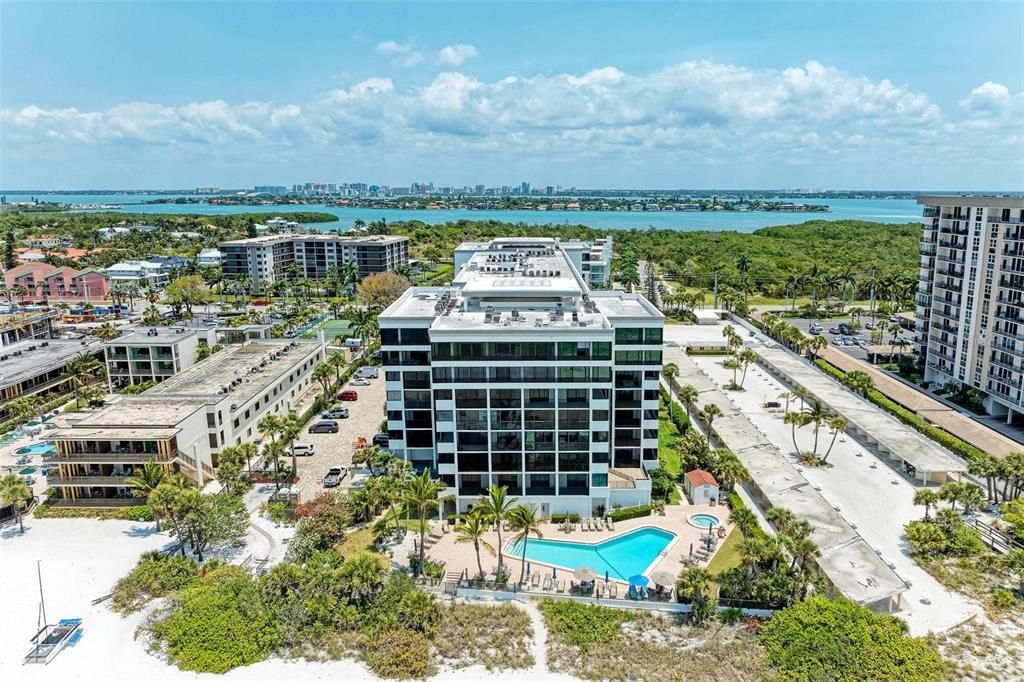 Welcome to the beach life! Beach right off of the pool and downtown in the background.