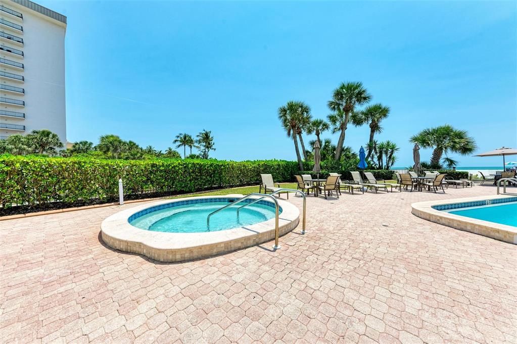 Watch beach goers pass by while relaxing in the hot tub