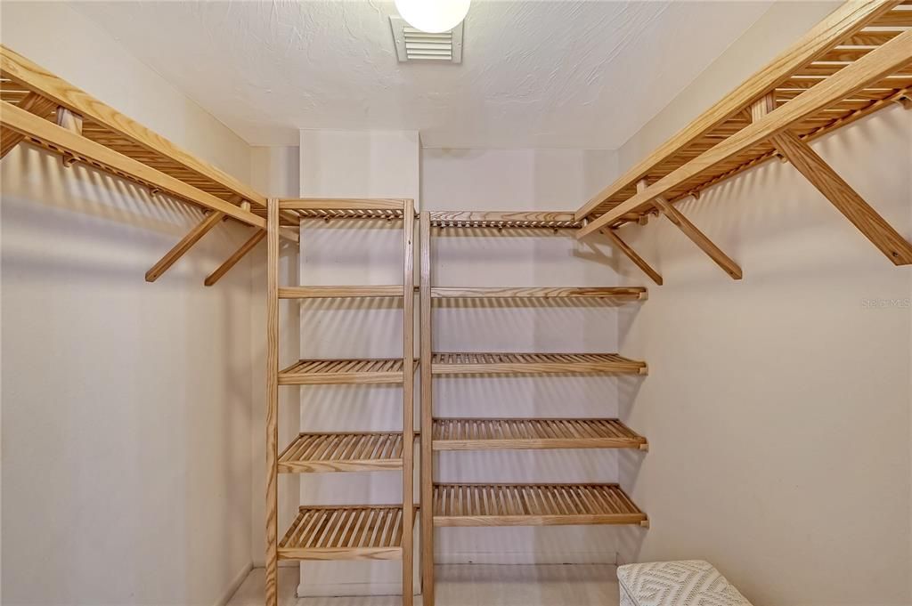 Primary walk in closet bamboo shelves