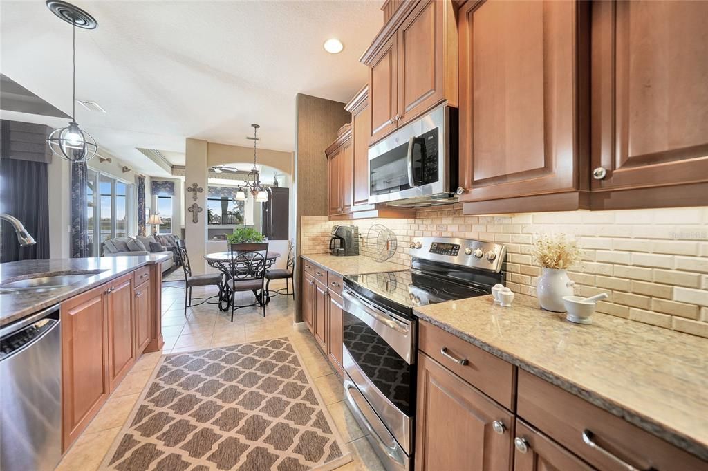 Great backsplash,counter space, granite and cabinets making this a happy kitchen