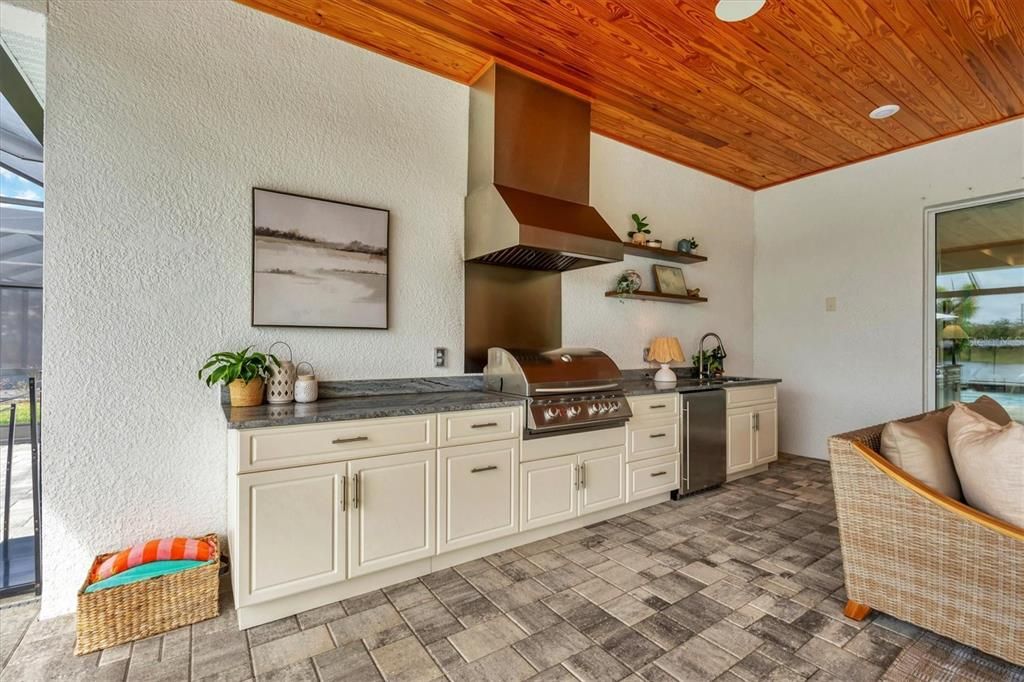 Outdoor Kitchen including Sink, Refrigerator and Grill