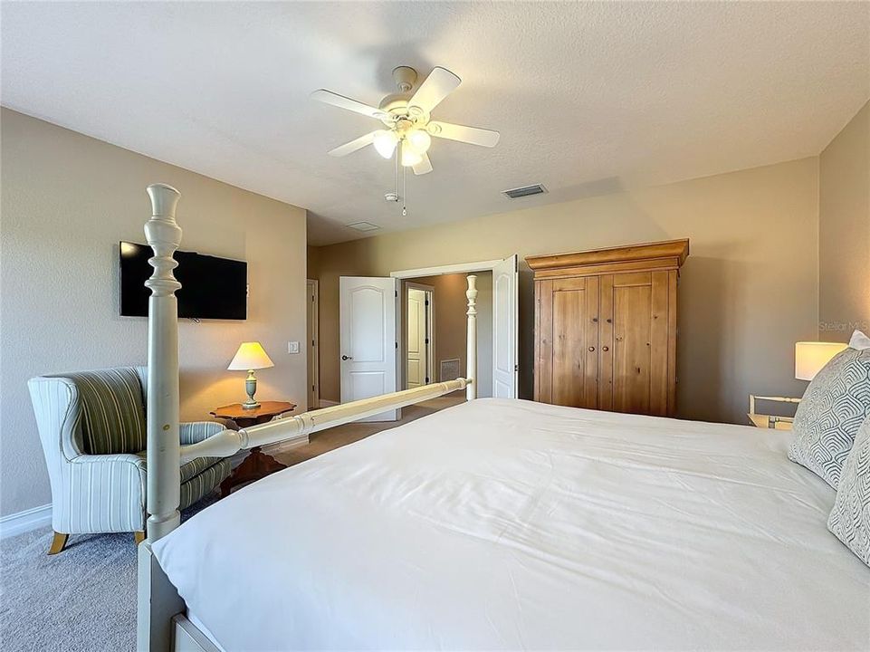 The guest bedroom is a spacious, serene retreat, designed to offer comfort and relaxation with a beautiful view of the golf course.