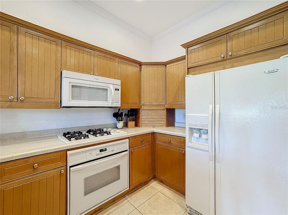 The kitchen is located in the heart of the home, seamlessly blending functionality and brightness from all of the windows and the French doors.