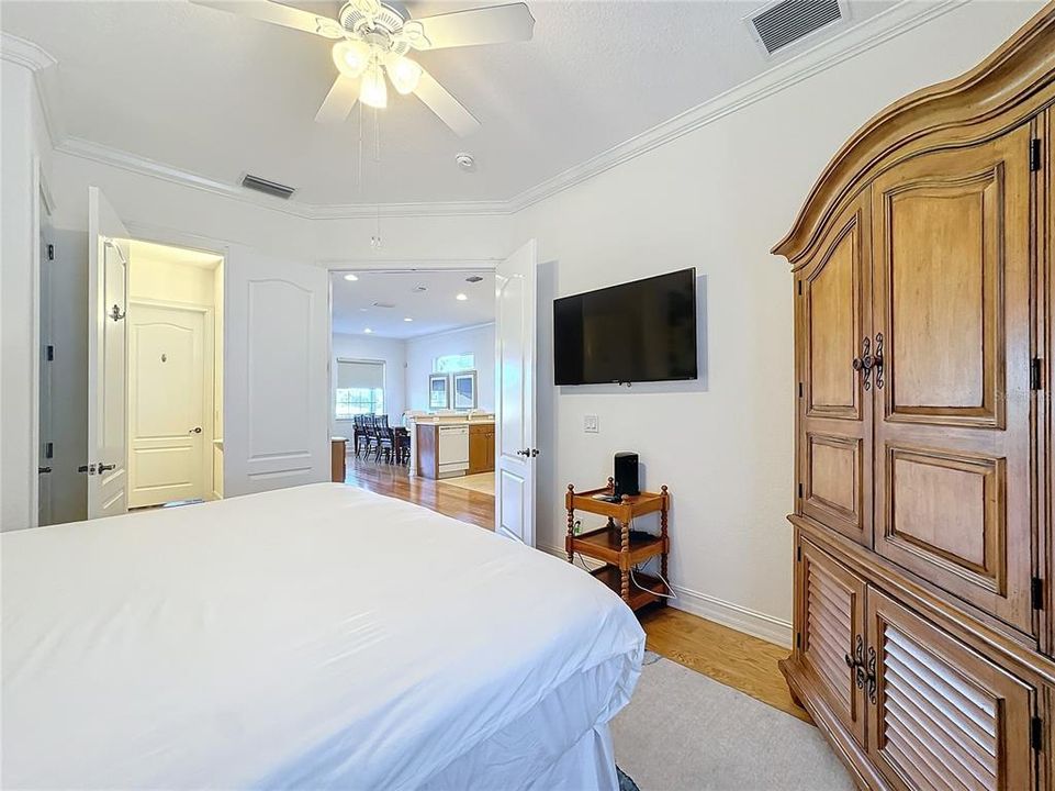 The downstairs bedroom, located just off the kitchen, is a serene and private retreat within the home.