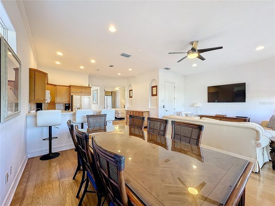 Flowing effortlessly from the dining area, the living room is a cozy, yet expansive space with plush sofas, and large windows that flood the room with natural light.