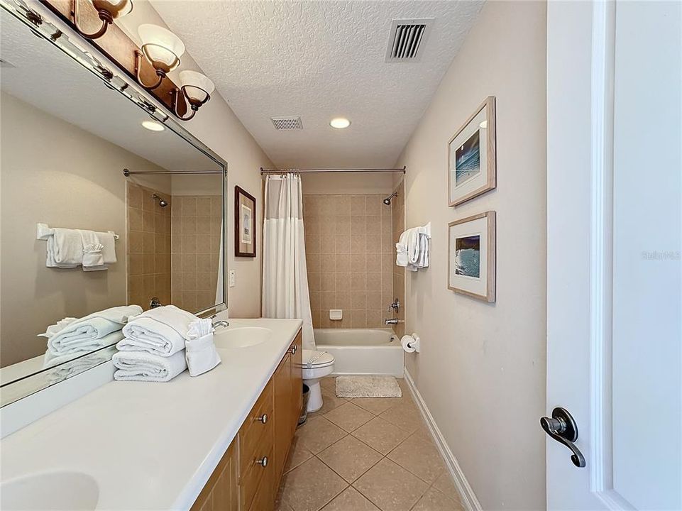 The guest bathroom provides a double sink vanity with enough room to spread out all of the toiletries.