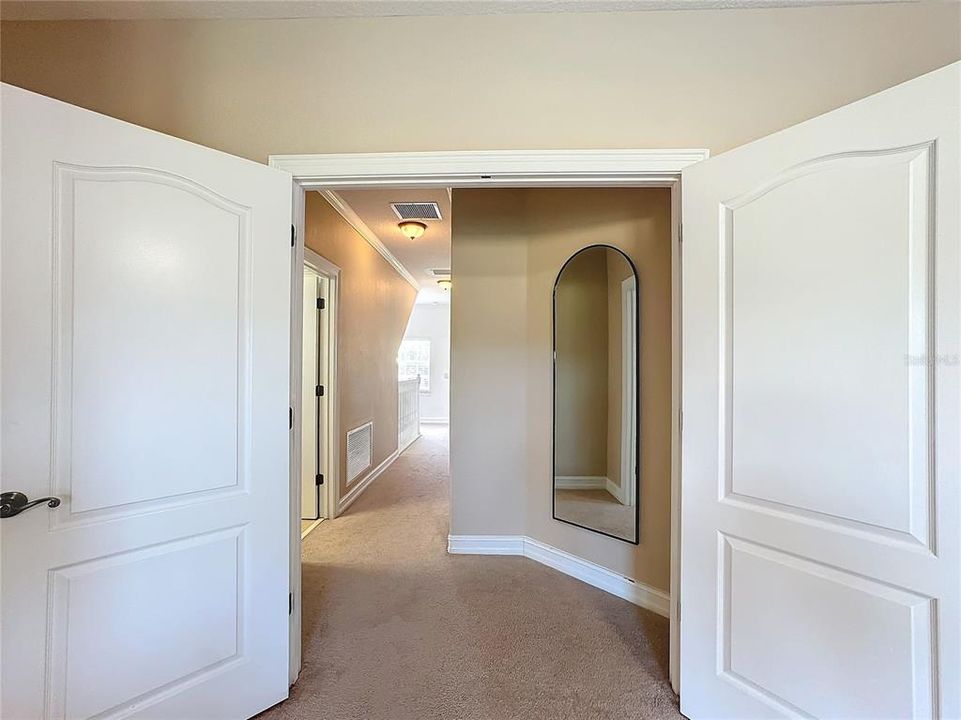 A view of the hallway leading to the laundry room.