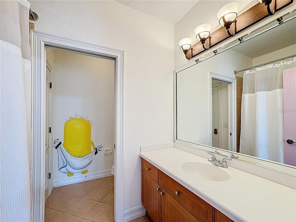 A fun guest bathroom for all that provides an owners' closet to lockup personal belongings.