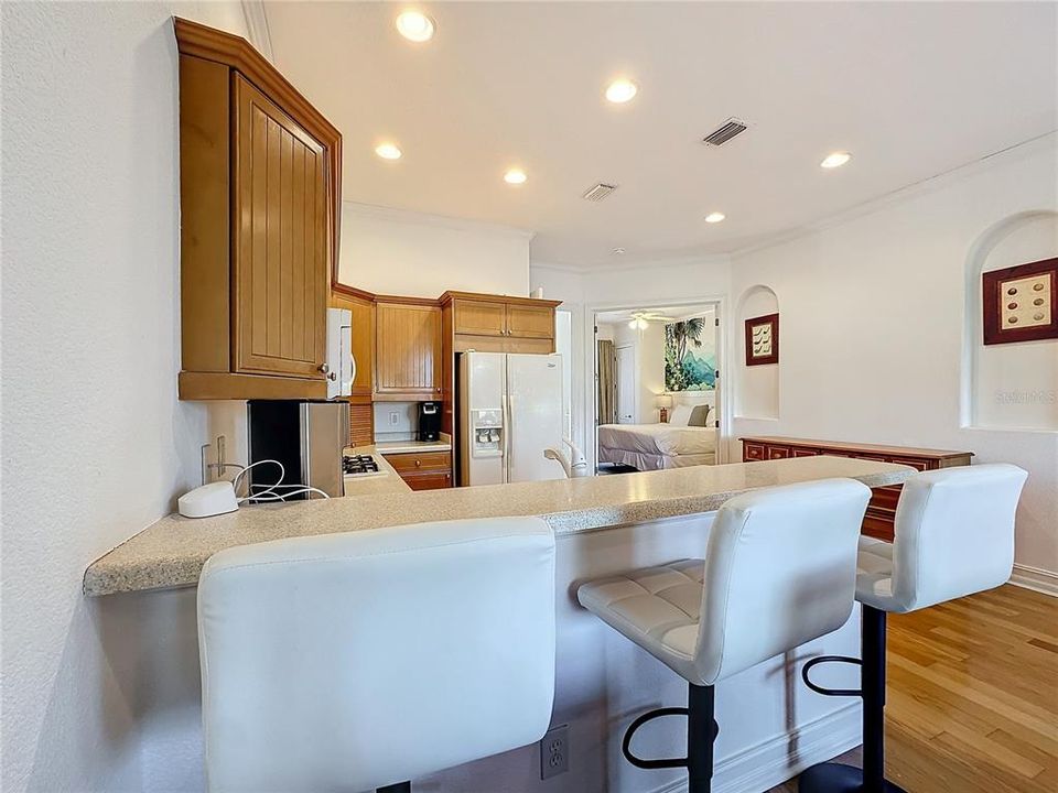 A view of the kitchen leading to the downstairs bedroom.