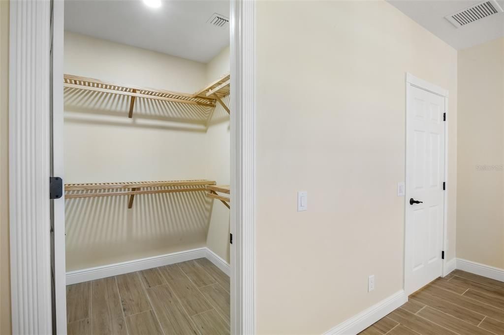 Primary bedroom walk in closet