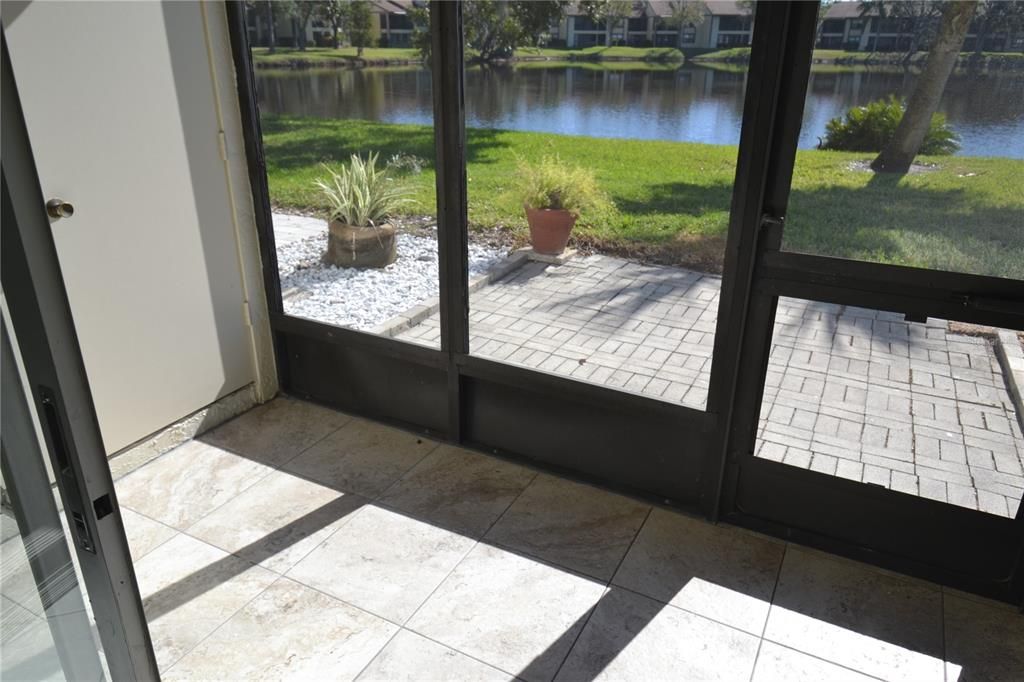 Newly tiled flooring outside and laundry area to the left