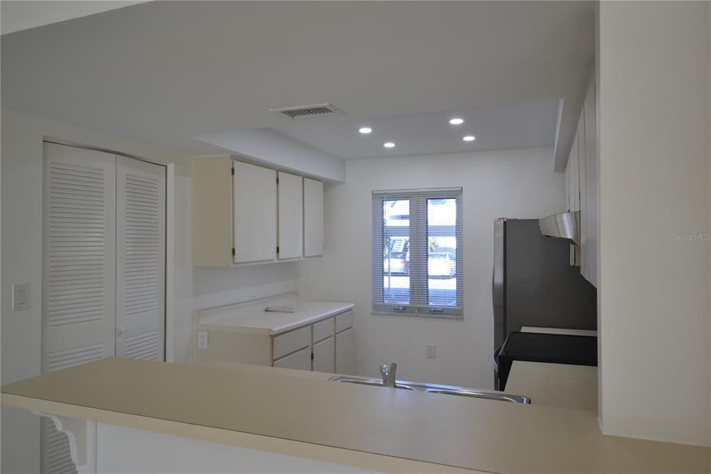 Kitchen with hurricane resistant windows and lots of cupboard space. New lighting as well and a pantry to the left